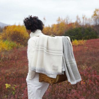 Swans Island Company's classic handwoven throws. Shown here the Grace throw in natural with grey stripes and the Heritage Throw in Grey with natural stripes.