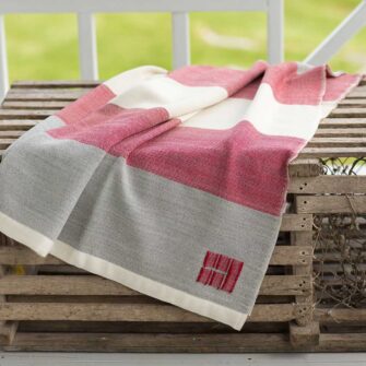 Swans Island Co.'s Maine Coast Throw - handwoven in Maine with soft merino wool. Shown here in Winterberry.