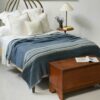 Swans Island Company's 100% Wool Blanket - The Grace Winter Blanket is handwoven in hand-dyed Indigo with undyed Natural stripes