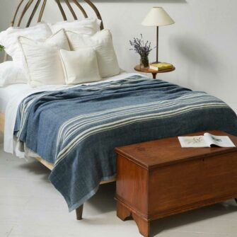 Swans Island Company's 100% Wool Blanket - The Grace Winter Blanket is handwoven in hand-dyed Indigo with undyed Natural stripes