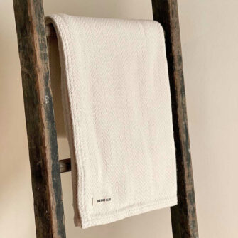 Swans Island's Belfast Herringbone Throw is a classic herringbone blanket in 100% natural cotton, woven in Maine.