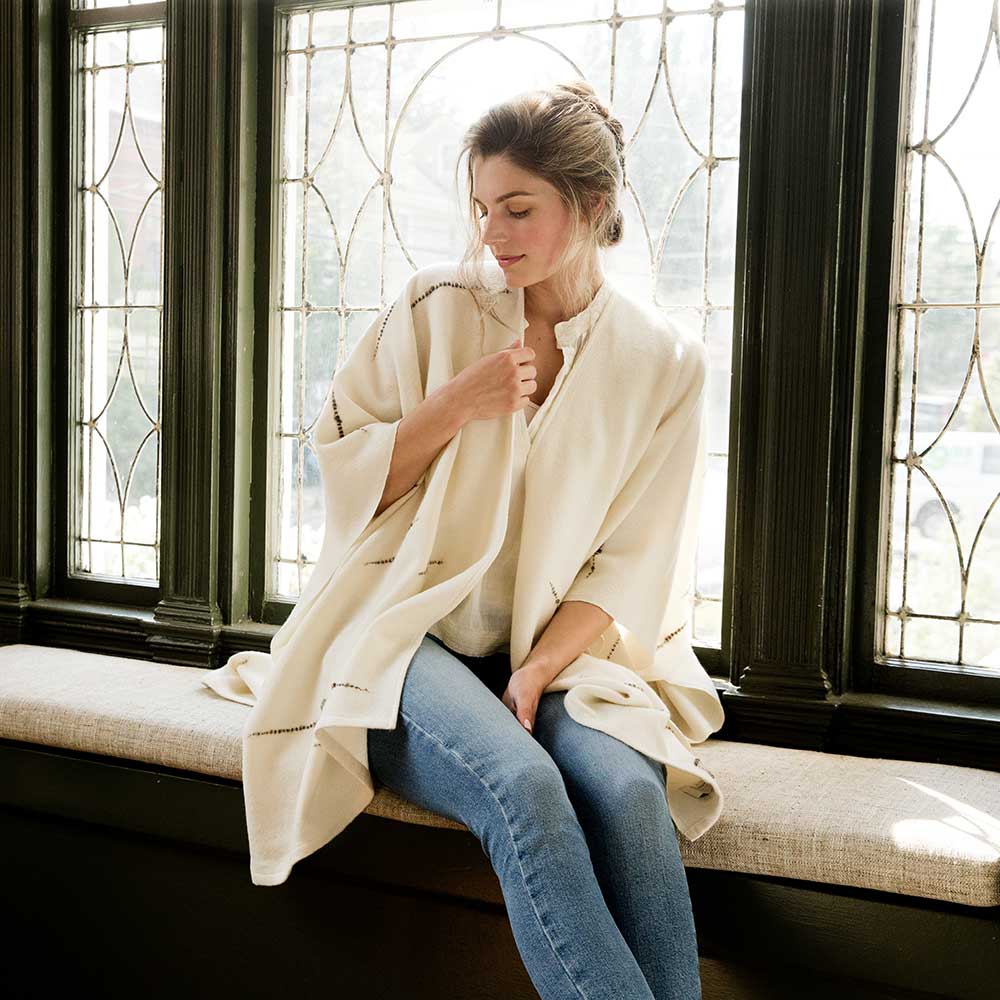 The Swans Island Whitecaps Cape is handwoven in Maine with soft merino wool with bits of textured wool reminiscent of whitecaps on the water.