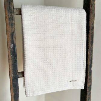 Swans Island Company's Tuscany Throw. 100% Cotton throw with allover basketweave texture woven in Natural undyed 100% American cotton.