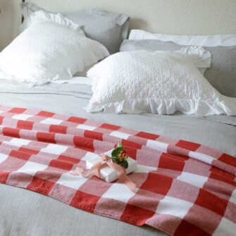 Swans Island Company's Cotton Gingham XL Check Blanket - woven in Maine on antique looms. Made with 100% soft American cotton. Shown here in Red and White.