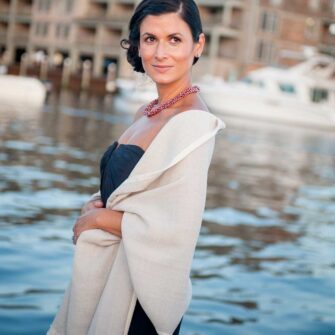 Celebrate your special day in Swans Island style with handwoven wraps for the whole bridal party. Soft organic merino wool and silk wraps are handwoven in Maine. Here, our bridesmaid wears the Boothbay Wrap in Fog.