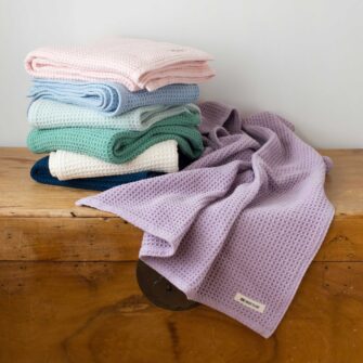 Swans Island Company's Cotton Waffle Toddler Blanket is squishy and soft - perfect for tender babes. Made in Maine with 100% American cotton. Shown here in a wide range of colors.