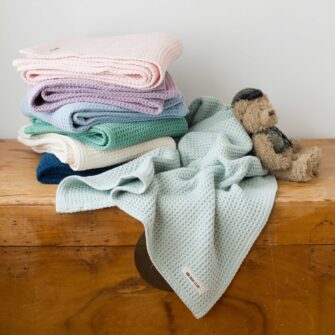 Swans Island Company's Cotton Waffle Toddler Blanket is squishy and soft - perfect for tender babes. Made in Maine with 100% American cotton. Shown here in a wide range of colors.