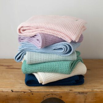 Swans Island Company's Cotton Waffle Throw Blanket is soft an cozy. A great gift for any home. Made in Maine with 100% American cotton. Machine washable. Shown here in a wide range of colors.