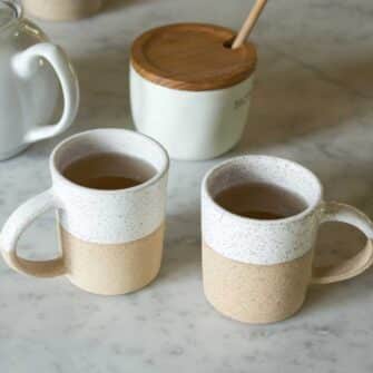 Swans Island Company's Shortie Mug is handcrafted with stoneware pottery dipped with a food-safe earthy glaze on top. Made in Maine. Shown here in White.
