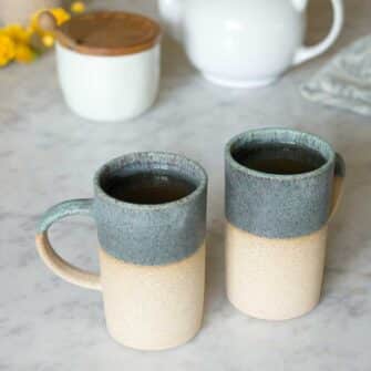 Swans Island Company's Tall Dipped Mugs are handcrafted with stoneware pottery dipped with a food-safe earthy glaze on top. Made in Maine. Shown here in Sage, set of two.