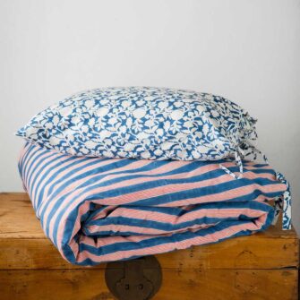 Swans Island Company's Indu Duvet Cover by Soil to Studio. Block printed by hand in India with bright playful patterns. Shown here in Indigo with Red Stripe. Paired with Amna shams in blue.