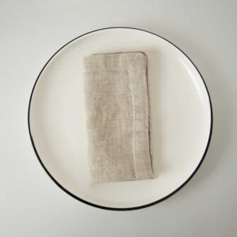 Swans Island Company's linen napkins by Linen Tales, made with 100% European Linen Oeko-Tex® and EUROPEN FLAX® certified. Made with stonewashed soft linen with mitered corners for a crisp edge. Shown here in Natural Flax color.
