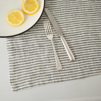 Swans Island Company's linen placemats by Linen Tales, made with 100% European Linen Oeko-Tex® and EUROPEN FLAX® certified. Made with stonewashed soft linen with mitered corners for a crisp edge. Shown here in Thin Black Stripe.