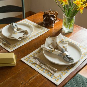 Swans Island Company's Shika Placemat by Soil to Studio. Block printed by hand in India with bright playful patterns. Shown here in Natural with daffodil yellow.