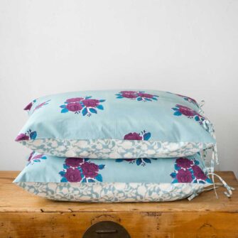 Swans Island Company's Sara Shams by Soil to Studio. Block printed by hand in India with bright playful patterns. Shown here in Denim with roses.