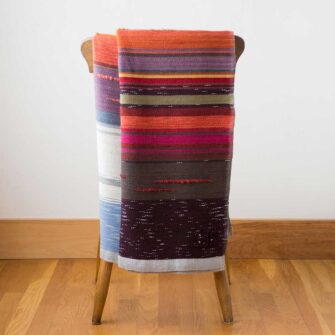 Swans Island Company's 2025 Limited Edition "Autumn in New England" Throw commemorates Yankee Magazines' 90th anniversary. This handwoven throw features 90 color changes in vibrant autumn hues of hand-dyed color. Made in Maine. Limited supply.