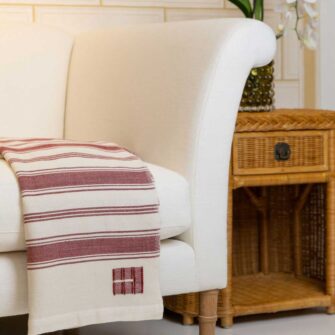 Casa Branca x Swans Island - Branca Stripe Throw . 100% soft merino wool with hand-dyed stripes and ivory silk binding. Handwoven in Maine. Shown here in Winterberry.